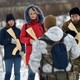 A military instructor teaches civilians holding wooden replicas of Kalashnikov rifles in Kyiv on February 6, 2022.