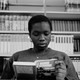 A young woman reads a book.