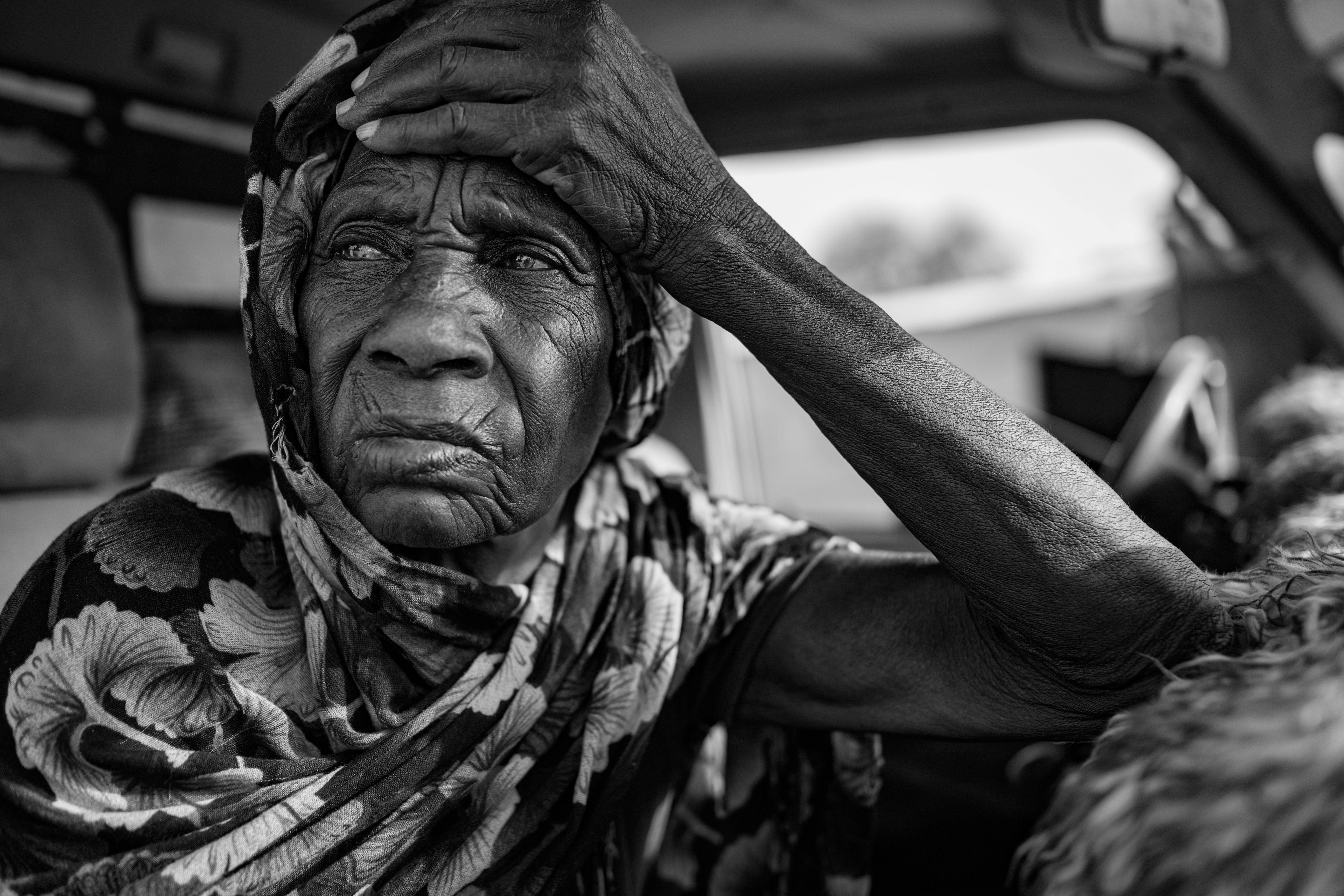 Picture of Om Juma Ahmed resting inside a truck in Tiné after a harrowing journey from Zamzam. 