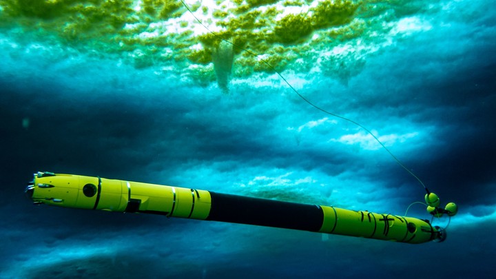 Icefin, a submersible robot, travels under Thwaites Glacier.