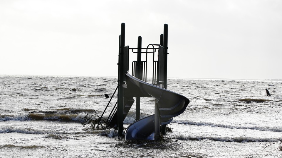 A playground slide stands surrounded by the storm surge of Hurricane Sandy, in Bellport, New York, in October 2012.