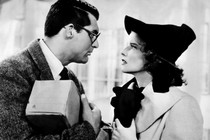 A still from the 1938 movie, Bringing Up Baby, with a man and a woman staring into each other's eyes.