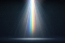 A rainbow-colored light shining down into a dark space