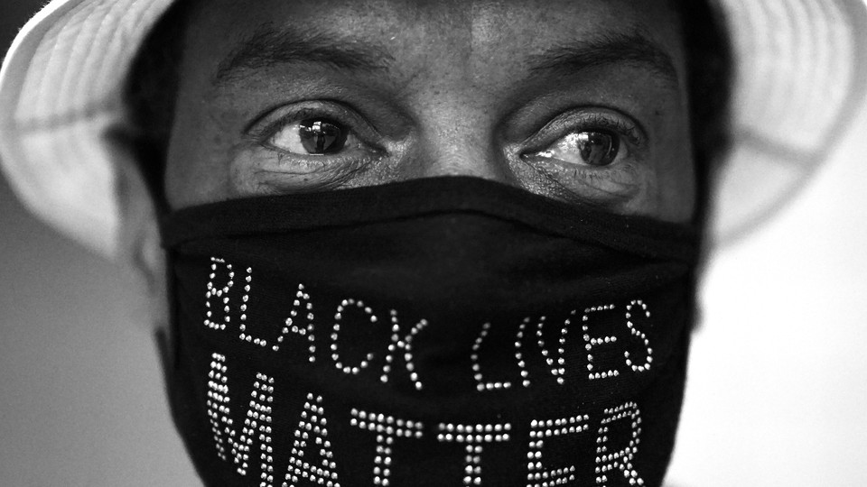 A person wearing a Black Lives Matter face mask.