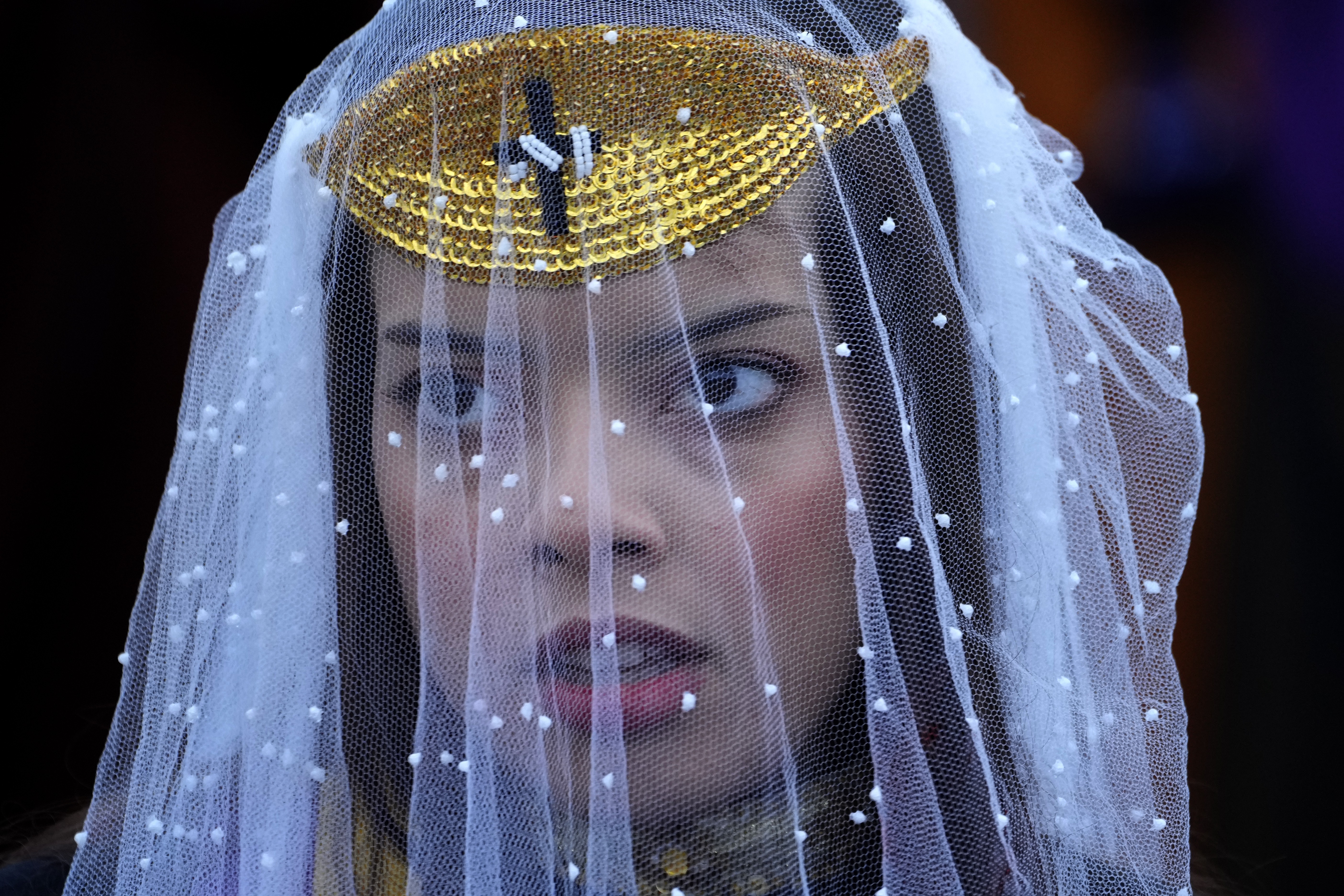 A person wears a decorative veil.