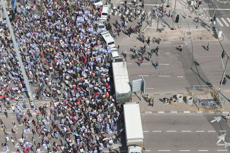 A crowd of protesters fills a street.