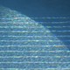 A blue pool with striped light reflections