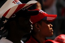 Black man and Latina wearing Trump hats