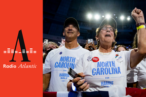 Delegates from North Carolina stand in a crowd, one raising her fist, at the Democratic National Convention