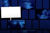 A placard in front of TV screens showing blurred images