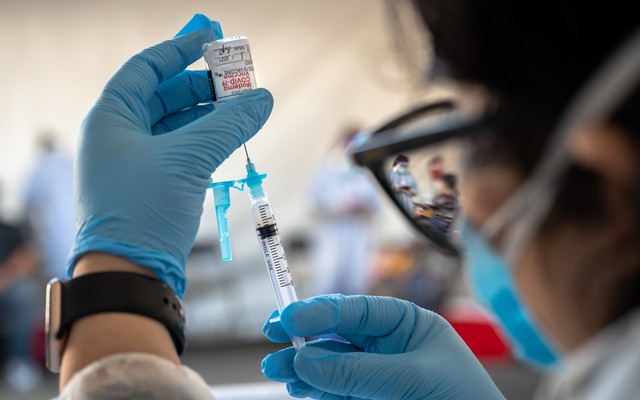 A health-care worker prepares a Moderna COVID-19 vaccine in San Francisco, March 1, 2021