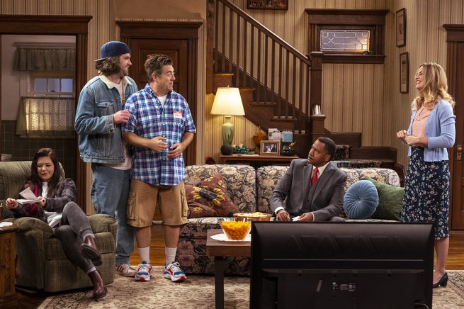 sitcom still of people in a living room