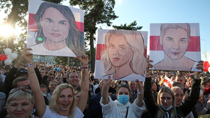 Women hold portraits of Sviatlana Tsikhanouskaya, Veronika Tsepkalo and Maria Kolesnikova at rally in support of Belarusian presidential candidatese Sviatlana Tsikhanouskaya.
