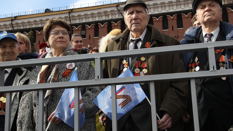 Russians at Victory Day parade holding Z flags