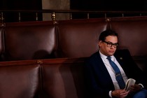George Santos sitting alone