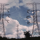 An image of transmission lines sitting atop two large metal structures