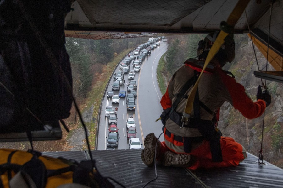 A view of two lines of stranded cars on a road, seen from aboard a rescue helicopter.