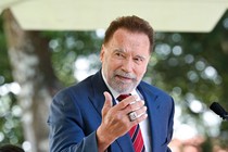 A photo of Arnold Schwarzenegger speaking at the annual naturalization ceremony at Mount Vernon.