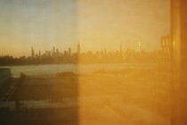 a hazy yellow view of a city skyline out of a window