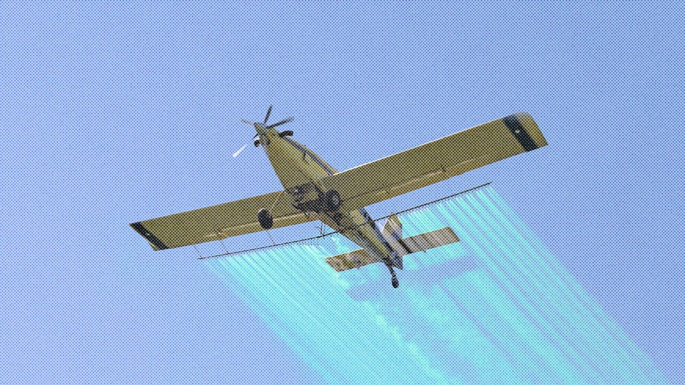 a plane streaks something across the sky