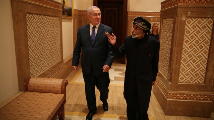 Benjamin Netanyahu walks with Sultan Qaboos bin Said.