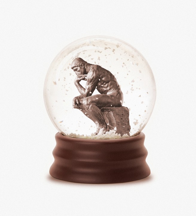 thinking man statue inside a snow globe