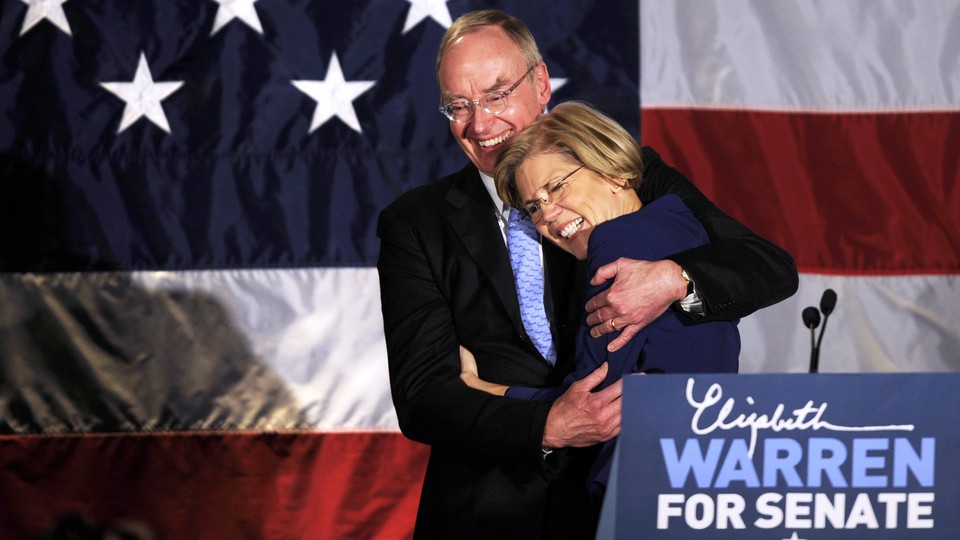 Elizabeth Warren and her husband, Bruce Mann, hug.