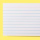 A lined index card on a yellow background