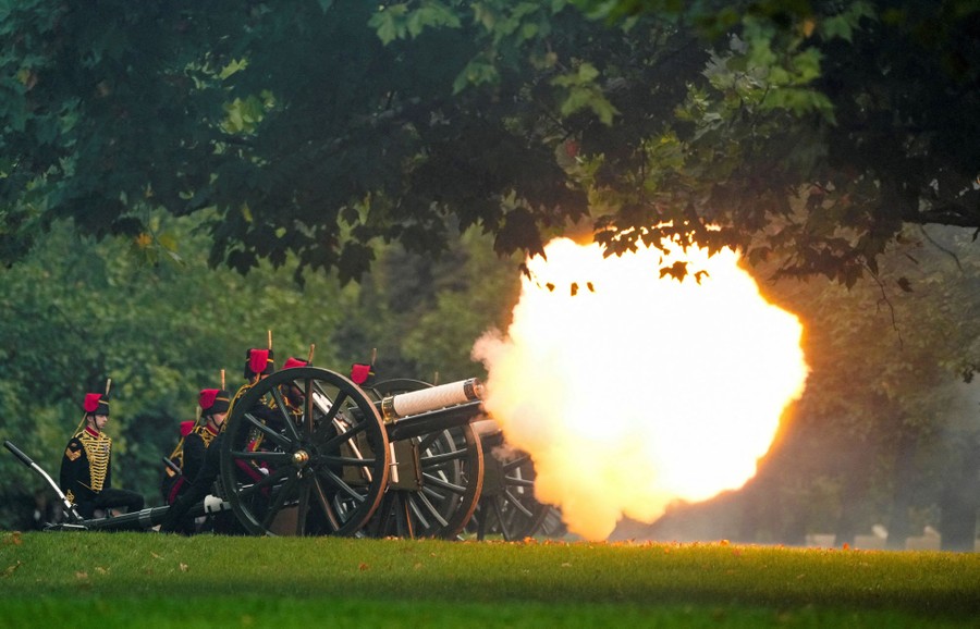 Soldiers fire a ceremonial cannon.