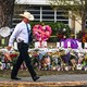 Police officer walking in front of a memorial