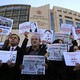 Demonstrators hold copies of Cumhuriyet outside the court where several of the newspaper's employees were on trial in 2017.