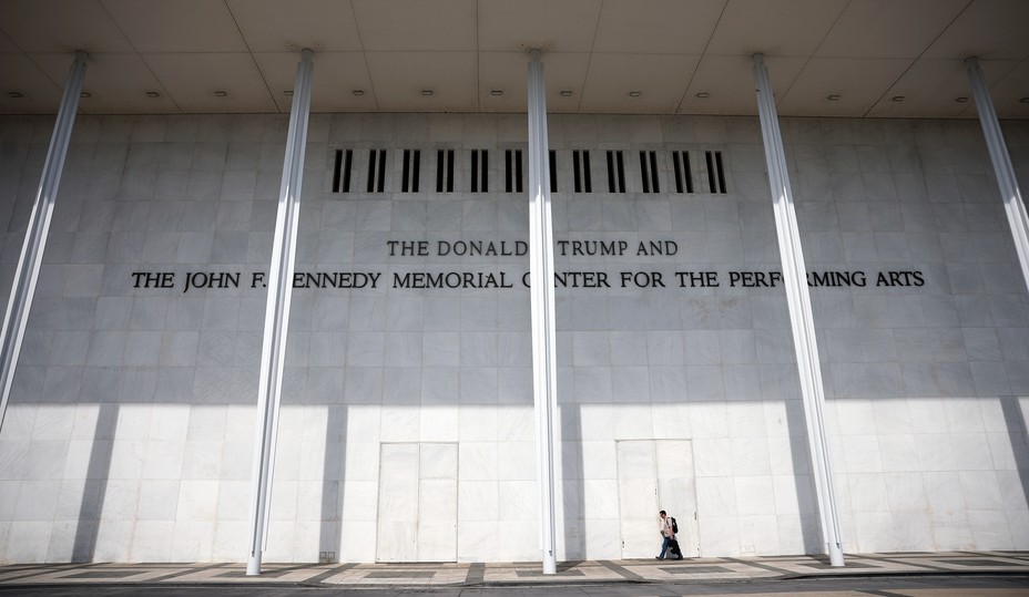 a person walks in front of the Kennedy Center