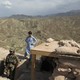 A U.S. soldier stands at a post in Nangarhar province alongside an Afghan civilian.