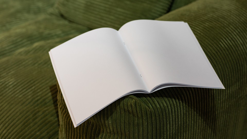 White empty magazine on green velvet sofa