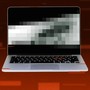 Illustration of a laptop with a pixelated screen in front of a red background