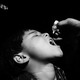 A child opens his mouth to receive the oral polio vaccine