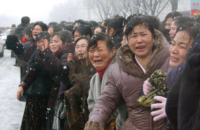 Many women cry passionately in a snowy landscape.