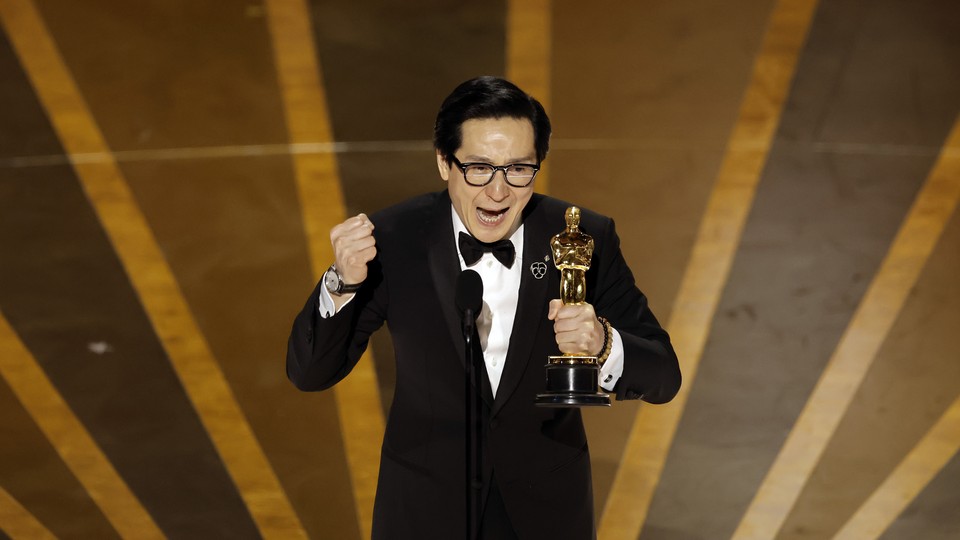 Ke Huy Quan holding an Oscar and giving his acceptance speech