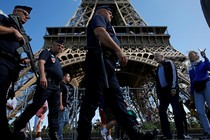 French policemen on patrol by the Eiffel Tower in Paris.