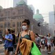 Pedestrians are seen wearing masks as smoke haze from bushfires in New South Wales blankets the central business district in Sydney.