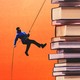 A person rappelling down a stack of books