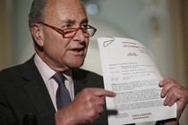 Senate Minority Leader Chuck Schumer of New York points to a copy of a White House–released rough transcript of a phone call between President Donald Trump and the president of Ukraine.