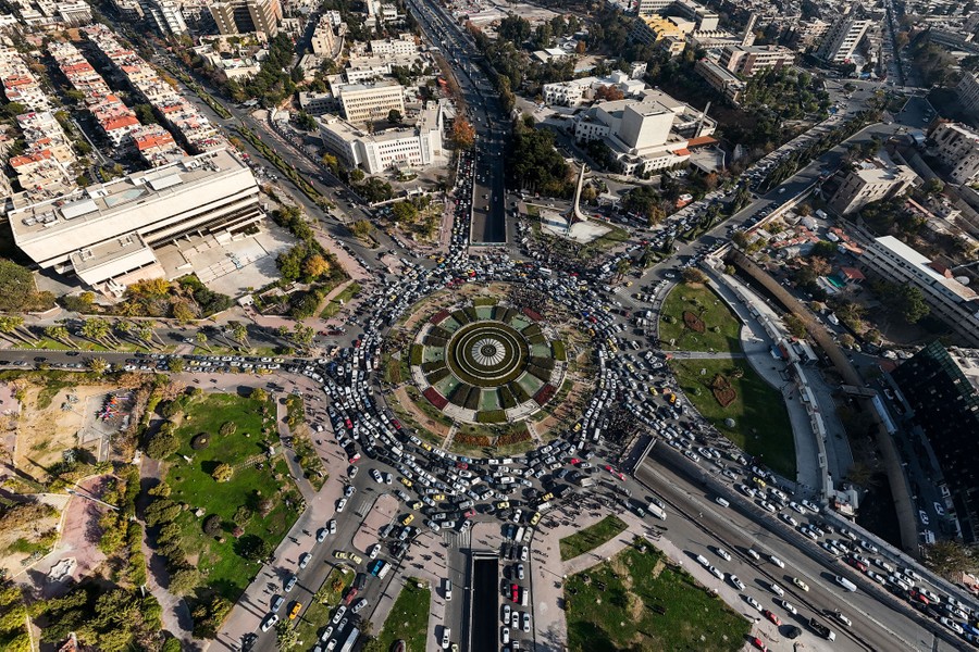 An aerial view of heavy traffic at a roundabout city square in Damascus