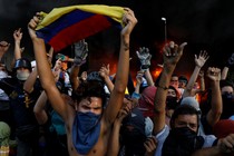 Protesters react in front of the entrance of a building housing the magistracy of the Supreme Court of Justice and a bank branch during a rally on June 12, 2017.