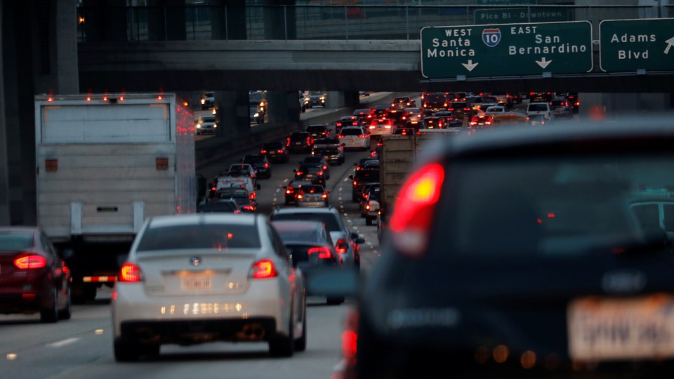 Cars and trucks drive in bumper-to-bumper traffic on a highway in Los Angeles.