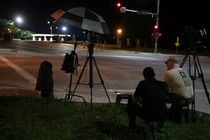 Media wait at the front gate of U.S. Army base Fort Leavenworth for the expected departure of Chelsea Manning in Leavenworth, Kansas, on May 17.