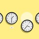 four clocks showing different time zones