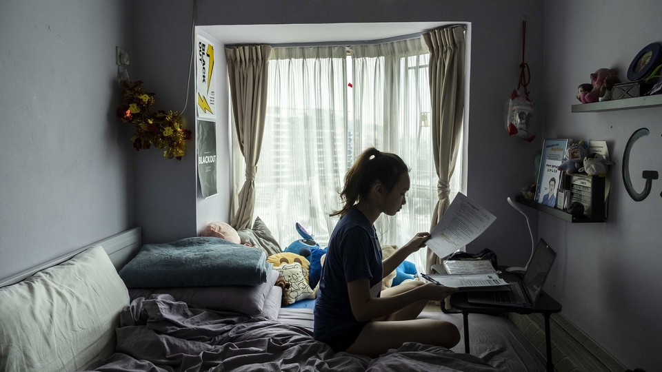 A high schooler in Hong Kong working on homework.
