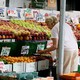 A woman picking fruit in a fresh market