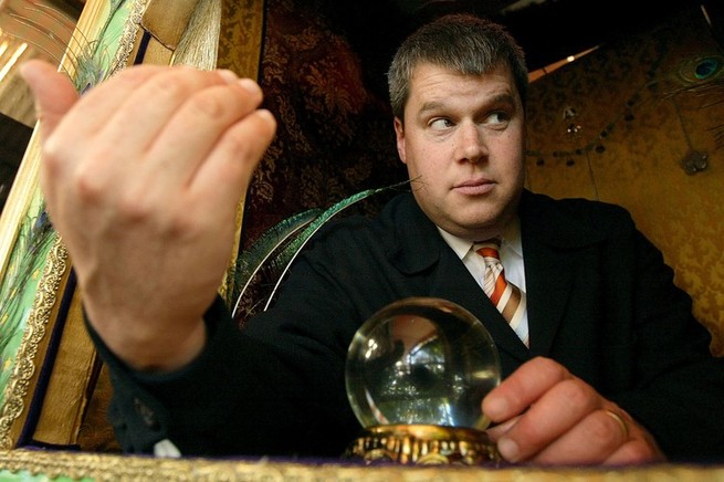 author Daniel Handler a.k.a. Lemony Snicket in a card reader booth with a crystal ball